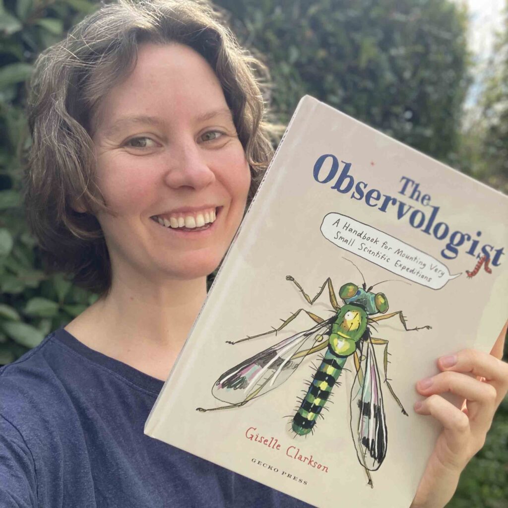Giselle Clarkson holding a copy of The Observologist